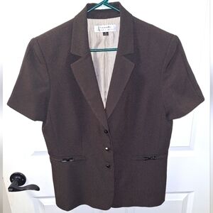 A Tahari short sleeve brown blazer in a ladies size 16. It features metal snaps.